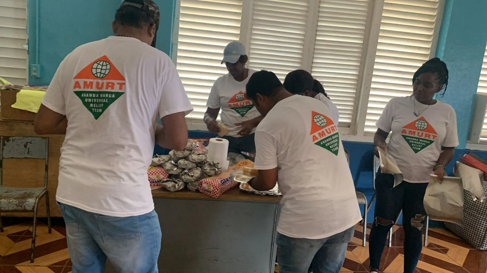 AMURT volunteers preparing care packages for hurricane-affected families in Jamaica