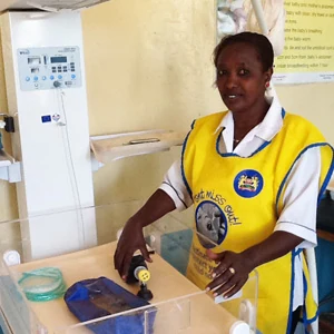 Nurse Orre standing beside the resuscitation couch. The new equipment makes the Wamba health facility more attractive for women. 