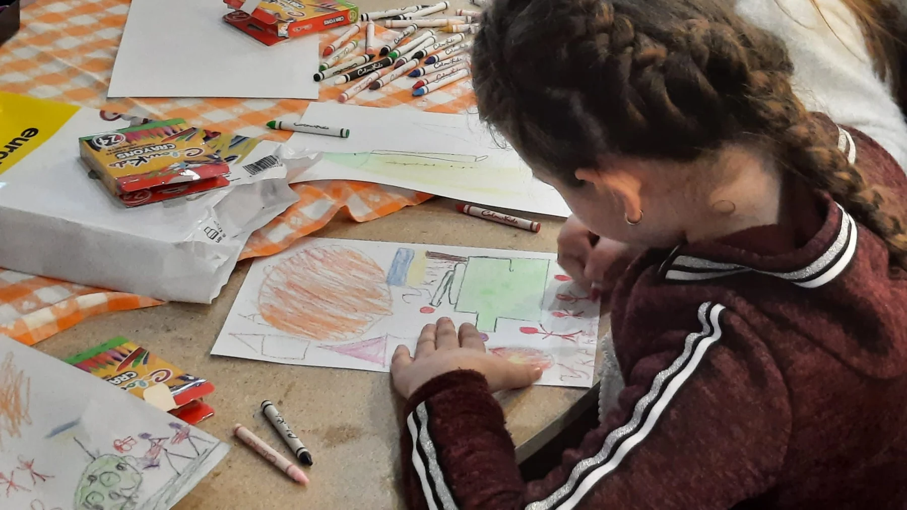 A child drawing in a child-friendly space during the Ukraine response